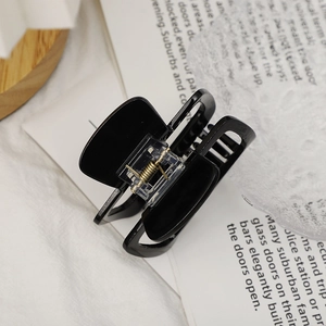 Chic black acetate hair claw clip with golden metal spring for daily hair styling