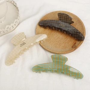 Elegant acetate checkered hair claws in brown, cream, and green with glossy finish