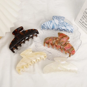 Large acetate claw hair clips in tortoise and marble patterns for elegant hair styling