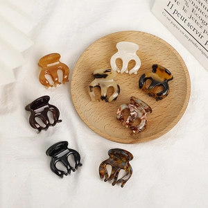 Mini acetate hair claws in amber and tortoiseshell patterns for bangs and ponytails