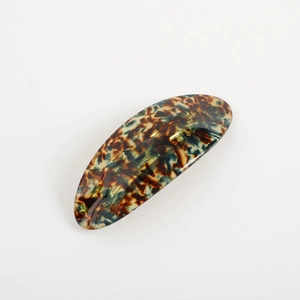 Polished tortoiseshell acetate oval hair clip with geometric spring barrette design
