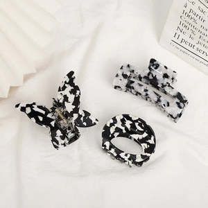 Three-piece black and white marble pattern hair claw set with butterfly and geometric shapes