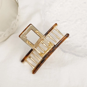 French style amber acetate hair claw with golden metal frame for elegant updos