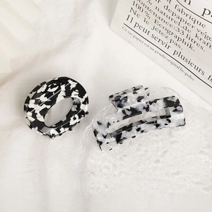 Elegant black and white marble acetate hair claws in oval and rectangular butterfly shapes