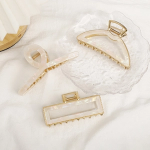 Three-piece set of cream acetate and gold alloy hair claws with marble texture patterns