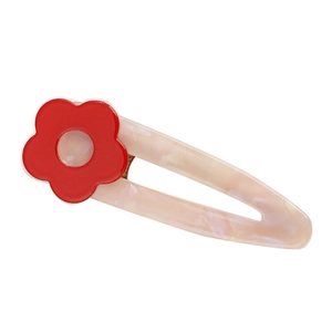 Detailed macro view of the pink marble texture acetate hair clip with a red flower