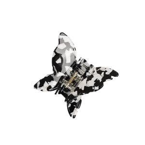Elegant butterfly acetate hair claw clip with black and white marble pattern and gold spring