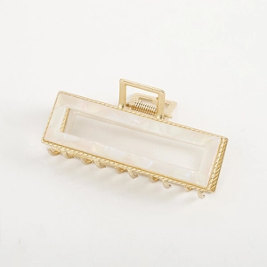Minimalist marble acetate hair claw clip with golden alloy frame for elegant hair styling