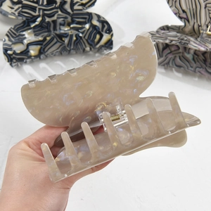 Oversized acrylic butterfly hair claw clip with marble texture and glittery finish