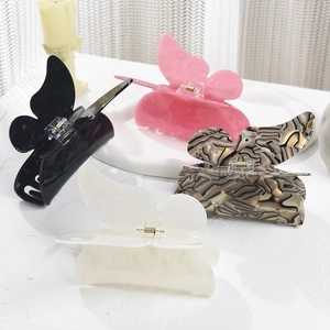 Detailed view of large acrylic butterfly hair claws in multiple elegant colors and patterns
