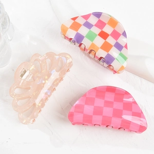 Three elegant acrylic claw clips with floral hollow and colorful checkered patterns