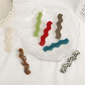 Set of seven colorful wavy acetate hair clips in candy colors with gold duckbill clips