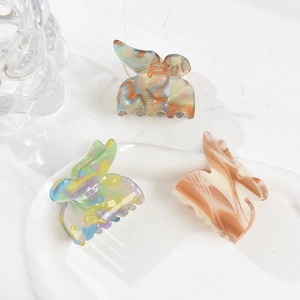 Three-piece acetate butterfly hair claws in marble and gradient colors for elegant styling