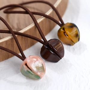 Detailed macro view of resin tulip-shaped hair ties with France handmade inscription