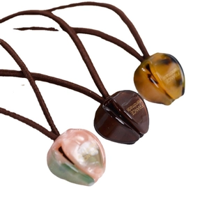 Three-piece French bow hair ties with resin heart charms in amber, brown, and green