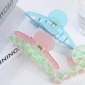 Checkered acetate hair claw clips in pink and green color block for hair styling