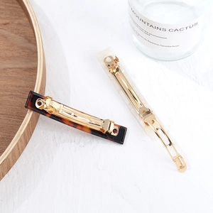 Minimalist heart acetate hair clips in tortoiseshell and marble patterns with gold metal