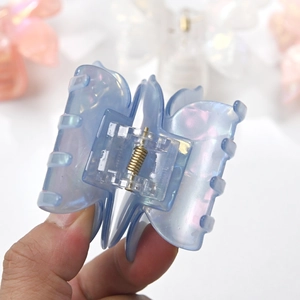 Iridescent light blue double-layered butterfly hair claw clip with golden metal spring