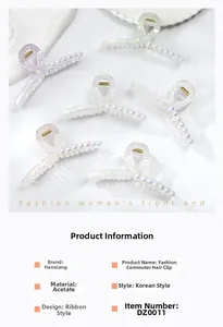 Detail view of acetate shark hair clips with pearl accents in multiple iridescent colors