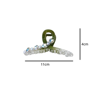 Detail view of green acrylic hair claw clip with crystal hearts and white pearls, 11cm size