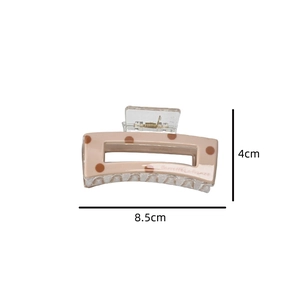 Detail of 8.5cm pink square hair claw clip with brown polka dots and Barrette La France text