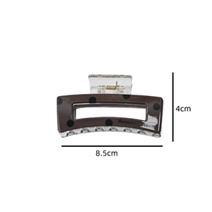 Detail view of brown polka dot hair claw clip with 8.5cm by 4cm size dimensions