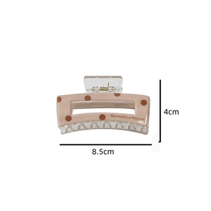 Detailed view of polka dot acetate hair claw clip with dimensions 8.5cm by 4cm