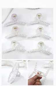 Detail of pearlescent claw clip showing strong spring and non-slip inner teeth structure