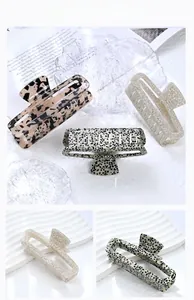 Macro view of rectangular acetate hair claws in leopard, spotted and marble patterns