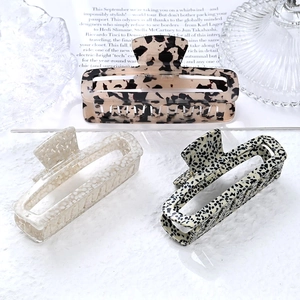 Three elegant acetate rectangular hair claws with tortoiseshell and marble patterns