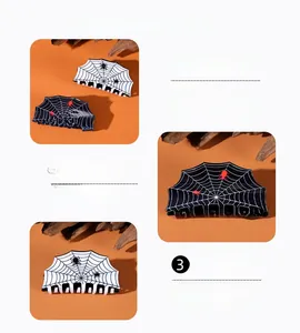 Detail of Halloween spider web hair claw clips in black and white finish on orange background