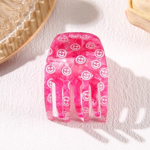 Pink marble acetate hair claw clip with white smiley face patterns for women
