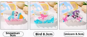 Detailed view of three acrylic Christmas hair claws with snowman and unicorn designs