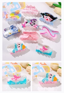 Macro detail of acrylic hair clips featuring various cute Christmas patterns and motifs