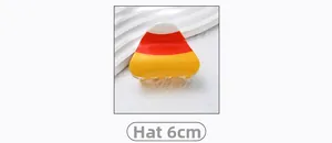 Detail of candy corn colored hair claw clip measuring 6cm on white textured background