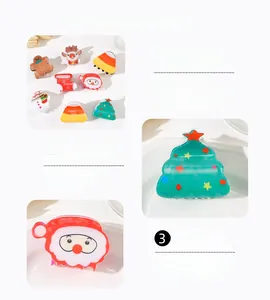 Detail view of smooth acrylic Christmas hair claws with festive deer and Santa designs