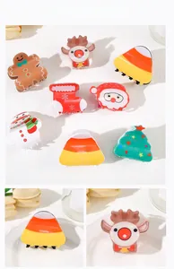 Detailed view of various acrylic Christmas hair claws with festive holiday patterns