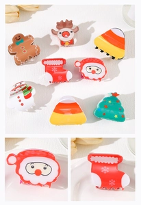 Close-up of colorful Christmas claw clips set featuring Santa, snowman and reindeer designs
