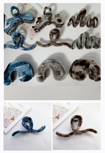 Detailed macro view of assorted French acetate hair claws with elegant marble textures