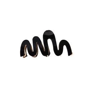 Glossy black wave-shaped hair claw clip with metallic spring on white background