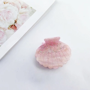 Pink shell acetate hair claw clip with colorful rhinestones for elegant hairstyles