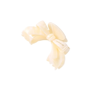 Detailed close-up of marble pattern acetate bow hair claw clip with handmade branding