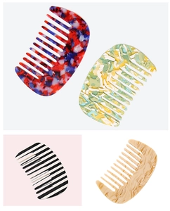 Detailed view of various acetate wide-tooth hair combs with elegant retro patterns