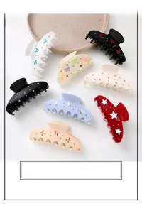 Various colorful rhinestone acetate hair claws arranged on a ceramic tray display