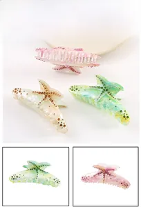 Detailed close-up showing gradient acetate starfish hair claws with colorful rhinestones