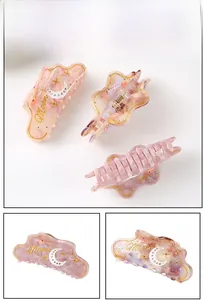 Detailed close-up showing acetate cloud hair claw with marble texture and moon pattern