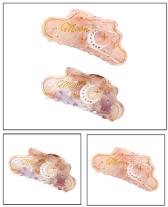 Detail of pink marble acetate hair claw clip with Moon gold text and rhinestone stars