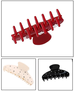 Detailed view of large rhinestone acetic acid hair claw clips in red, white, and black colors