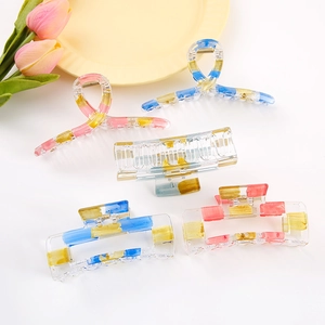 Artistic rectangular hair claws set with colorful paint splatters and golden springs