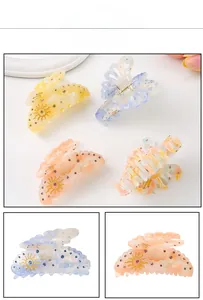 Detailed macro of acetate butterfly hair claw clips with sun patterns and rhinestones
